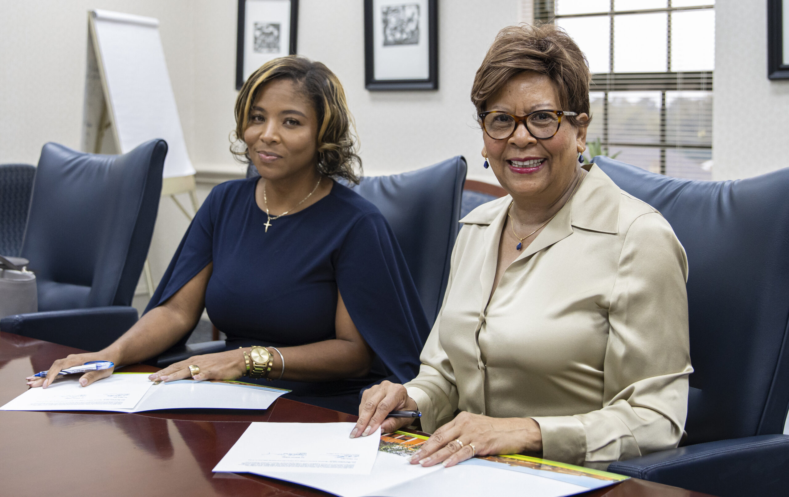 Two Black women sign a contract