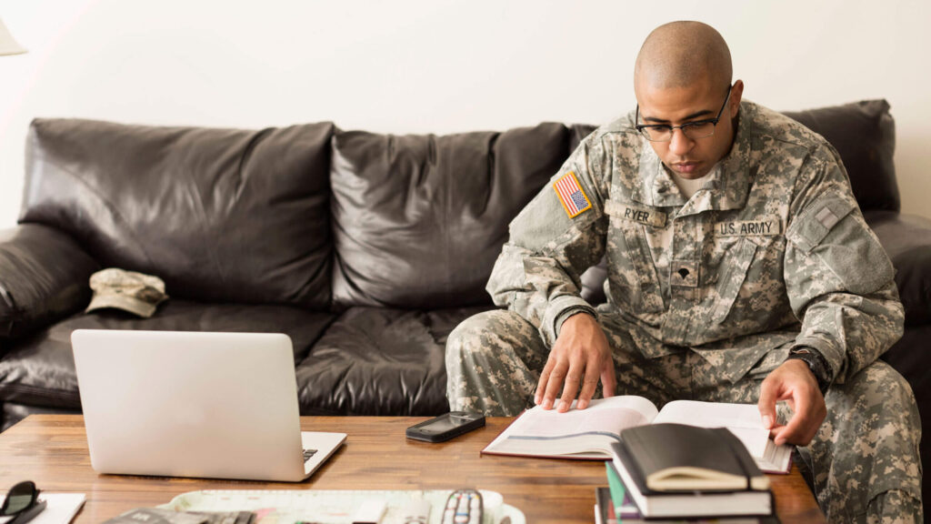 veteran student soldier studying on sofa-